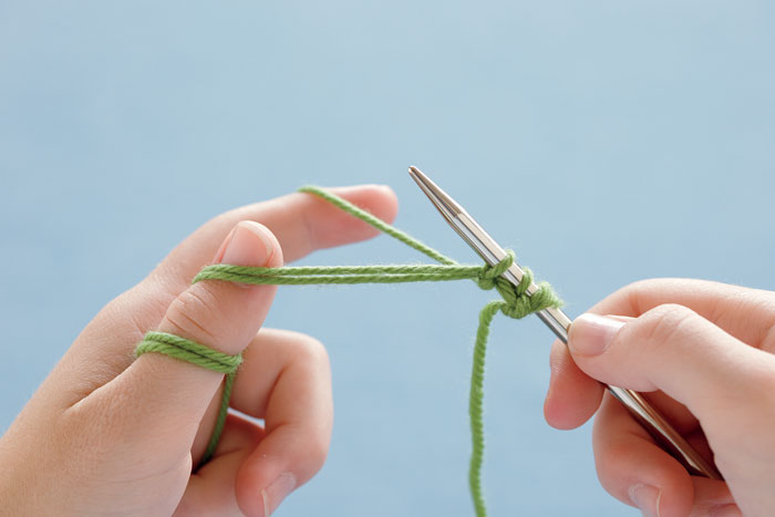 Drop the yarn from your thumb and pull on the ends to snug the stitch.
